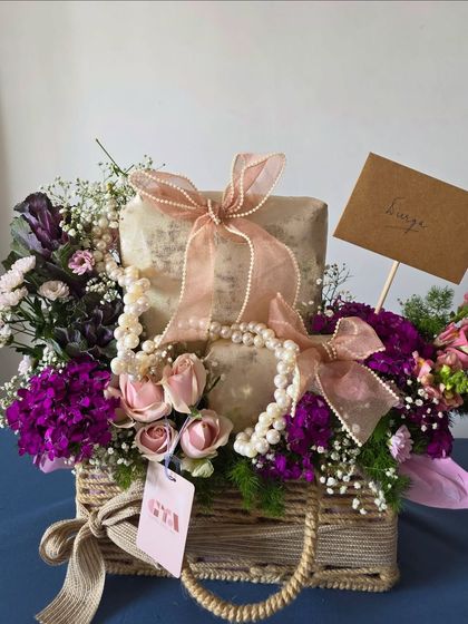 Another angle of the charming wicker basket hamper, highlighting the careful placement of each gift and floral element to create a balanced and beautiful composition.