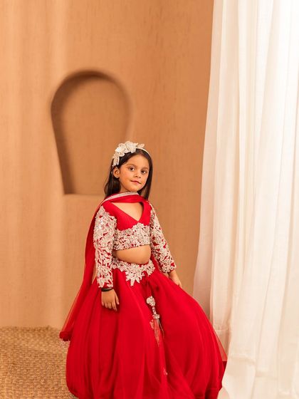 A newer design from our 2024 collection, this red lehenga features delicate white embroidery on the blouse and a voluminous skirt.