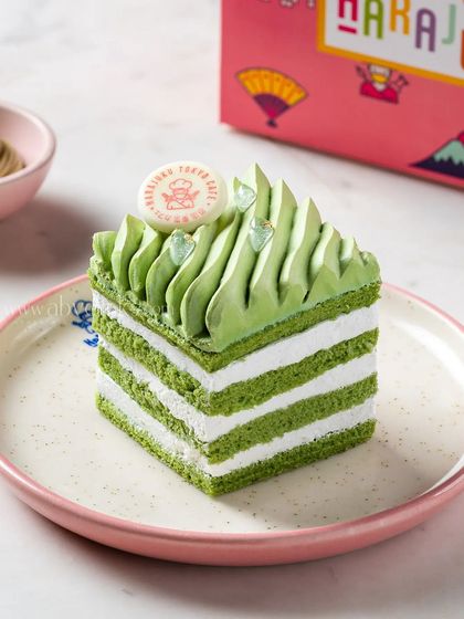 A matcha and white chocolate layered pastry, showcasing its clean lines and vibrant green color for a Japanese-inspired dessert menu.