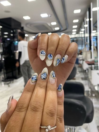 A stunning example of Korean blue marble nails with gold chrome accents, created for a client at the Aakar Beauty Expo.