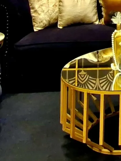 The theme extended to every piece of furniture. This custom coffee table features a gold-finished geometric base and a mirrored top that reflects the intricate patterns of the decor, tying the whole look together.