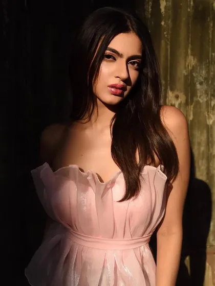 This portrait plays with shadow and light. The makeup is designed to look beautiful even in partial shadow, with the lip color providing a vibrant pop.