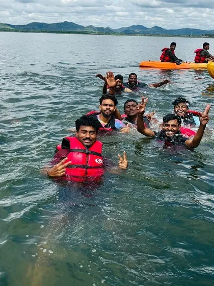 Happy faces and peace signs all around as a group enjoys a swim during their aqua sports camp.