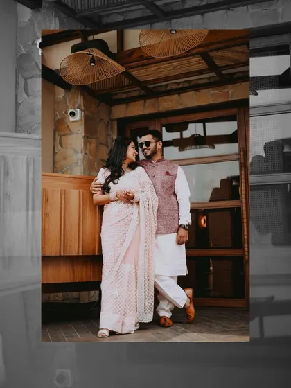 A stylish shot of the couple during their Roka. The pose is confident and modern, and the edit gives it a cool, slightly desaturated look that complements their outfits and the venue's rustic charm.