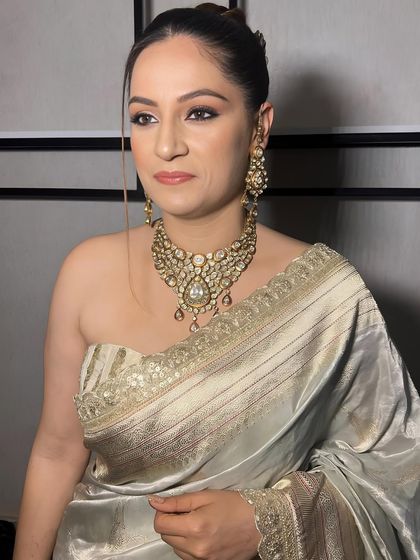 A side profile showing the beautiful updo and the flawless makeup.