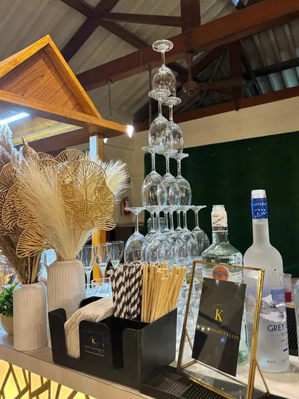 We believe the right glassware elevates the drinking experience. This setup features a tower of stacked wine glasses and elegant pampas grass decor, showcasing our commitment to sophisticated presentation.