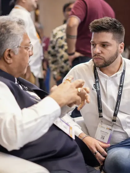 A senior industry figure shares insights with a younger professional. The expo serves as a mentorship and knowledge-sharing platform across generations.