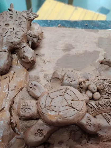 A close-up of a detailed turtle sculpture made by a child. The textures and patterns show a wonderful level of care and attention.