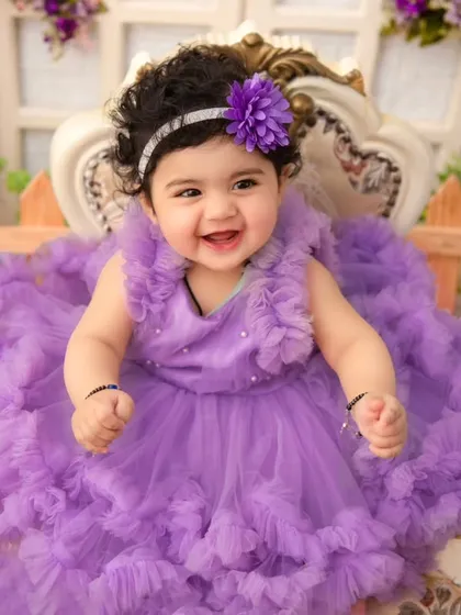 The simple elegance of a portrait. Dressed in a beautiful lavender gown, this little girl's joyful smile is the centerpiece. Sometimes, the most magical photos are the ones that capture pure, simple happiness.
