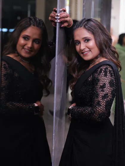 A reflective moment in a stunning black saree. The makeup is soft yet defined, perfect for an evening of celebration.