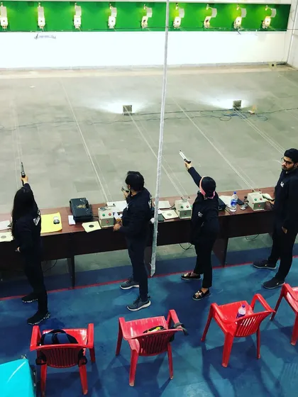 Our team in action at a championship. This view highlights the focus and discipline of our shooters as they take their positions at the firing line, ready to compete.