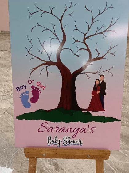 A creative guest book alternative for a baby shower, where guests can add their thumbprints as leaves on a tree.