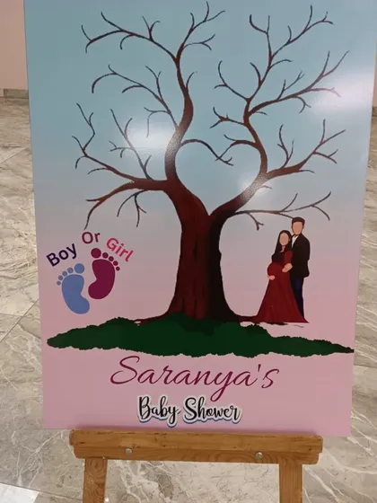 A creative guest book alternative for a baby shower, where guests can add their thumbprints as leaves on a tree.