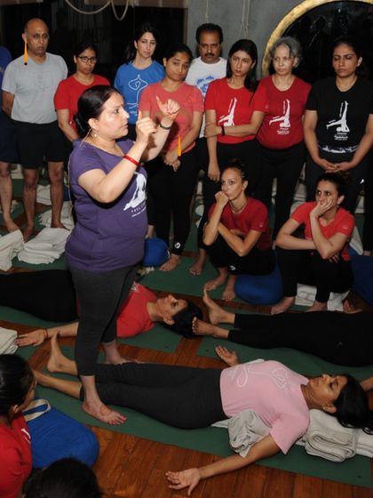A class in Savasana (Corpse Pose), with me explaining a point. Even in relaxation, there is learning and awareness. This is a crucial part of integrating the practice.