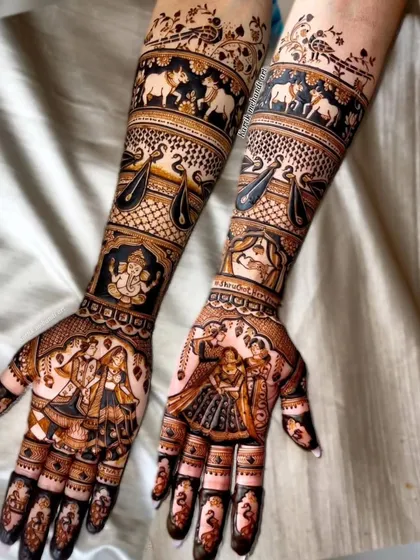 A perfect example of our full-coverage traditional bridal mehandi. This design features incredibly detailed figures, including a varmala scene, Lord Ganesha for blessings, and bands of elephants and swans, all executed with fine lines and perfect symmetry.