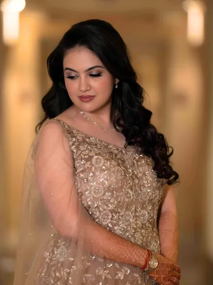 A beautiful portrait of the bride-to-be. Her soft, romantic makeup and gentle waves create an effortless yet glamorous look for her engagement.