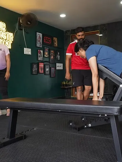 Here I am coaching a client on proper form for an incline row. At BASE, we focus on teaching the 'why' behind every movement in a supportive group setting.