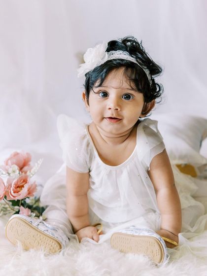 Another adorable portrait of the six-month-old birthday girl, looking like a little doll.