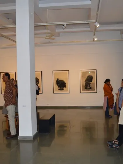 Visitors viewing the large drawings on paper by Shakuntala Kulkarni.