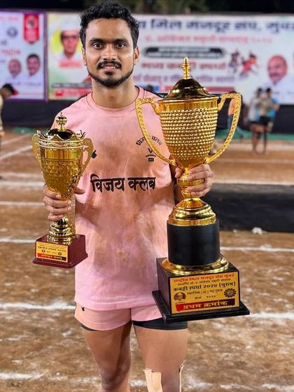 Our player proudly displaying his 'Best Player' trophies after the tournament.