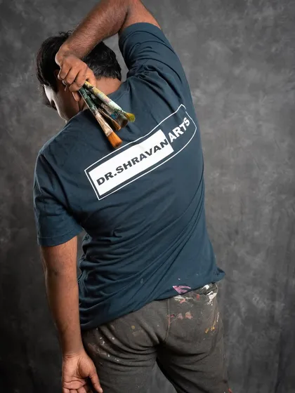 Remember the name! A shot from a photoshoot that captures the artist behind the art. My work clothes are my uniform, and my brushes are my tools.