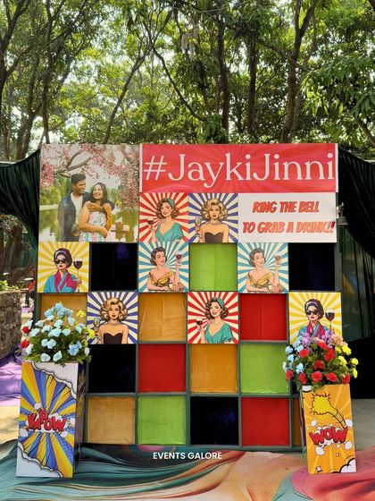 An interactive 'grab a drink' wall was a fun and engaging element at the Haldi. The retro pop-art design and the custom hashtag made it a popular spot for photos.