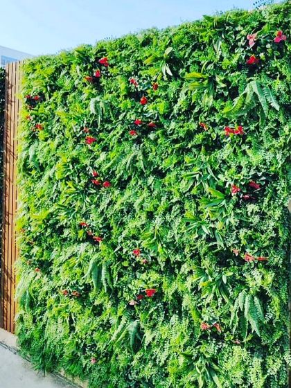 This outdoor privacy screen is made from a dense artificial vertical garden. It's a great way to cover a plain fence or wall and make your yard feel more secluded and lush.