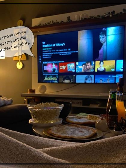 It's movie time! Our system knows what that means. We can program a scene that automatically dims the lights to create the perfect cinematic experience at home.