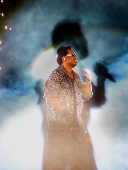 An artistic shot using smoke and backlighting to create a powerful silhouette effect behind the performer. This photo highlights our creative approach to live event photography.