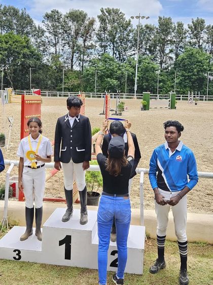 A rider being awarded a medal on the podium. Each medal represents countless hours of practice and a deep commitment to the sport.