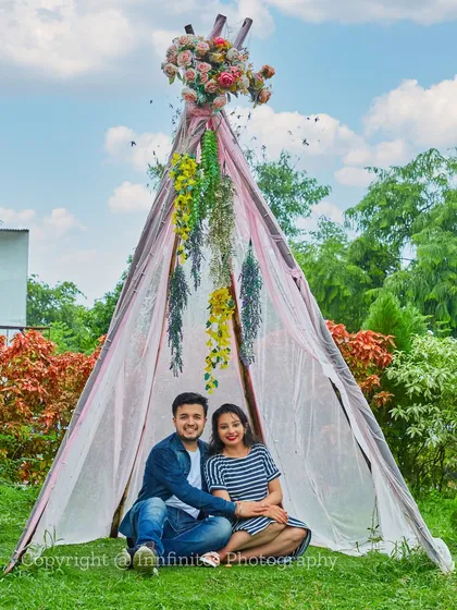 Our rustic teepee set, decorated with flowers, offers a charming and bohemian backdrop for a daytime pre-wedding shoot.