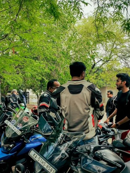 A candid shot from our anniversary meetup. Members chatting and checking out each other's bikes, a common sight at our gatherings.