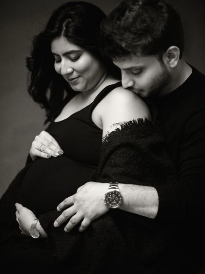 This close-up black and white shot focuses on the gentle touch and loving expressions, creating a powerful and emotional image.