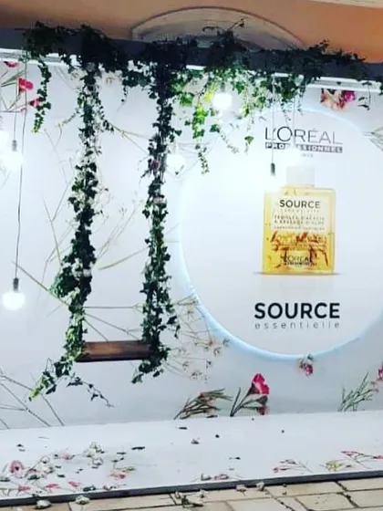 We design and construct completely custom photo booths tailored to your brand's aesthetic. This elegant setup for L'Oréal Professionnel features a floral backdrop, soft lighting, and a hanging swing to perfectly match their 'Source Essentielle' product launch.