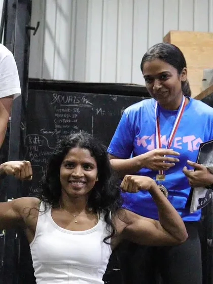 A female champion flexing her hard-earned muscles at THE OG BAR WARS #1. This is a testament to her dedication and strength.