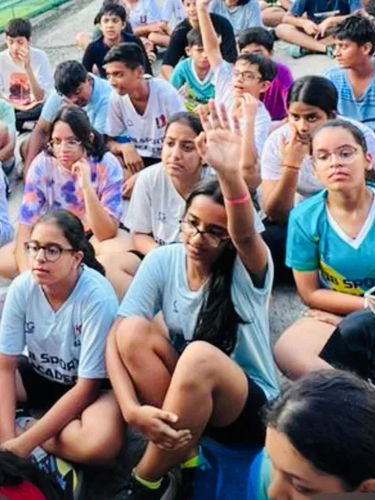 An engaged student asks a question during our gut health workshop. We believe in educating our players on all aspects of well-being, including nutrition.