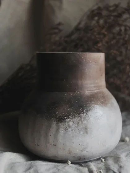 I call this pit-fired vase 'Stardust'. I achieved this subtle, speckled effect by throwing sawdust onto the piece when it was still hot from the fire. It’s a beautiful, earthy piece for dry arrangements.
