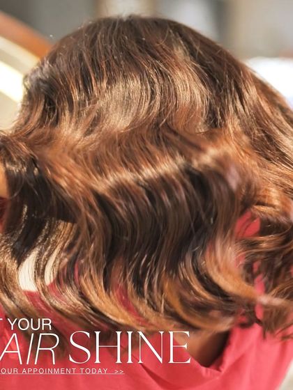 A close-up shot of freshly colored and styled hair, highlighting the shine and rich tones achieved with our professional products.