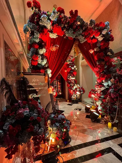 For a touch of mystery and glamour, we created this dramatic Masquerade theme entrance. Rich red drapery, lush florals, and opulent details set the stage for an unforgettable pre-wedding reception.