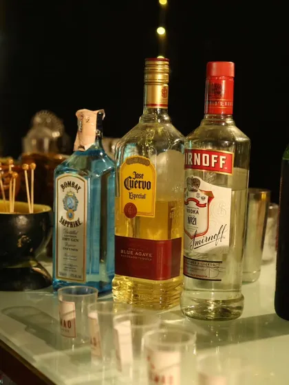 We stock our bars with a premium selection of spirits to craft our cocktails. Here you can see classics like Bombay Sapphire Gin, Jose Cuervo Tequila, and Smirnoff Vodka, ensuring quality in every drink.