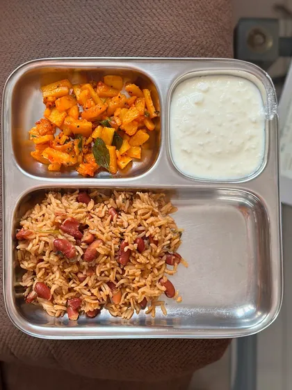 A gluten-free meal of peanut rice, sautéed potatoes, and curd. This is a simple and flavorful vegetarian lunch option.