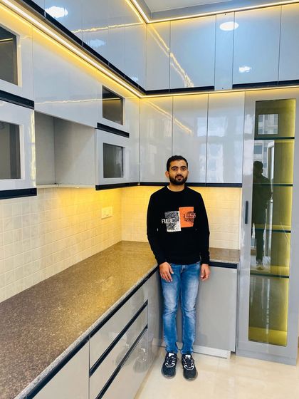 Proudly presenting another completed kitchen project. This design features grey high-gloss cabinets with black profile handles and a tall glass pantry.