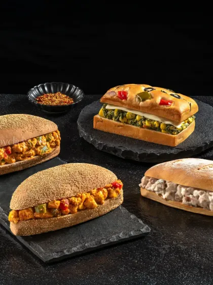 An assortment of freshly made sandwiches and paninis, showcasing the variety available at Barista.