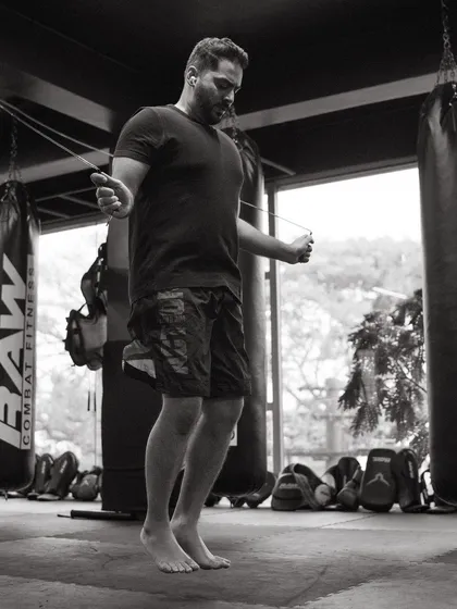 A fighter works on his cardio and footwork with a jump rope, a classic and essential tool for any combat athlete.