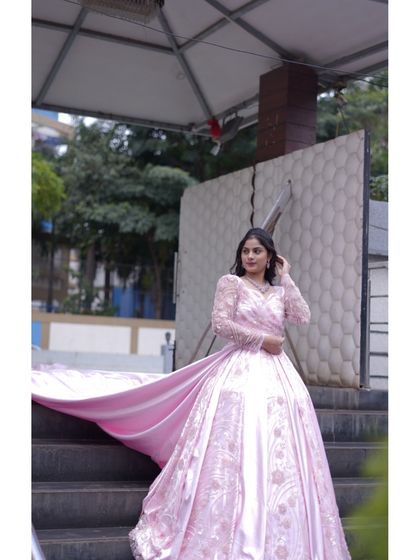 The dramatic trail of the pink gown is on full display here. This is the kind of outfit that makes you feel like you are in a movie, perfect for a grand finale to your wedding celebrations.