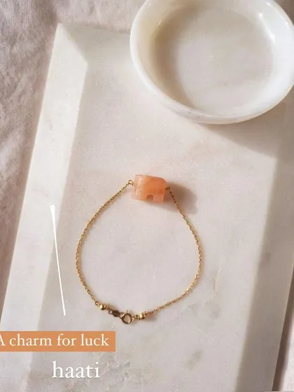 A simple shot of the 'haati' peach moonstone elephant bracelet. It's a charm for luck and a reminder of your inner strength.