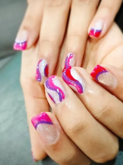 A vibrant and colorful abstract design with waves of pink, purple, and white glitter on a sheer base.