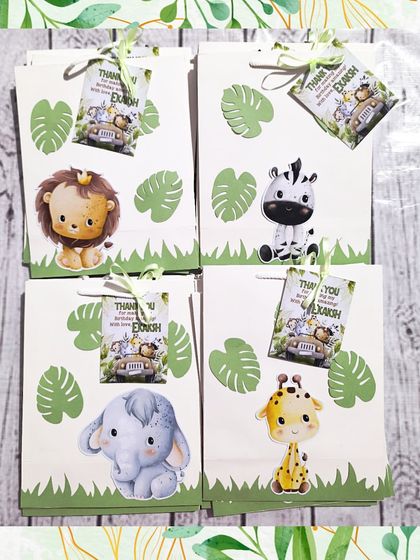 The packaging makes all the difference. These jungle-themed paper bags feature four different adorable animals: a lion, zebra, elephant, and giraffe, with custom thank you tags.