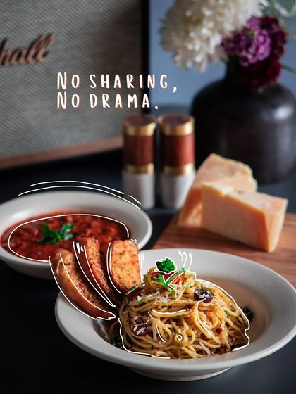 No sharing, no drama. A comforting plate of spaghetti aglio e olio with a side of arrabbiata sauce and garlic bread, just for you.