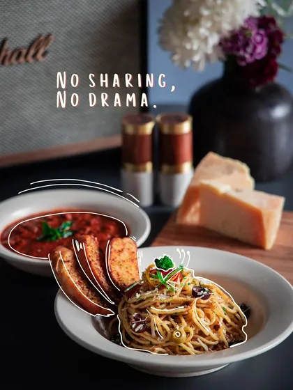 No sharing, no drama. An Italian pasta dish served alongside a rich tomato-based soup and garlic bread.